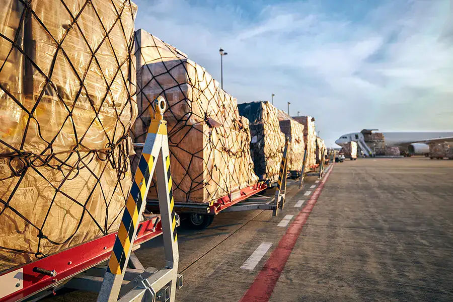 Limajari Cargo Transportation Cargo transportation at Limajari Cargo with large shipments loaded on flatbed trucks at an airport or logistics hub.