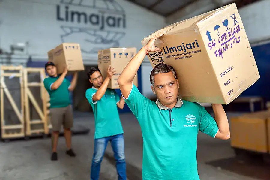 Limajari Cargo Team Loading Boxes Cargo team members from Limajari Cargo loading large boxes for transportation, demonstrating efficient logistics and packaging services.