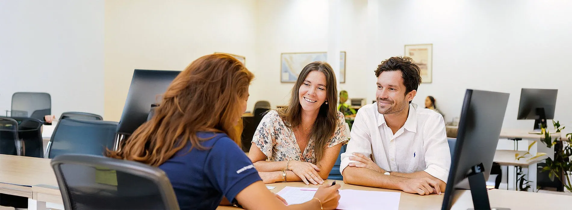 Business professionals discussing cargo logistics and shipping solutions in a modern office setting, emphasizing reliable freight services and customer support.