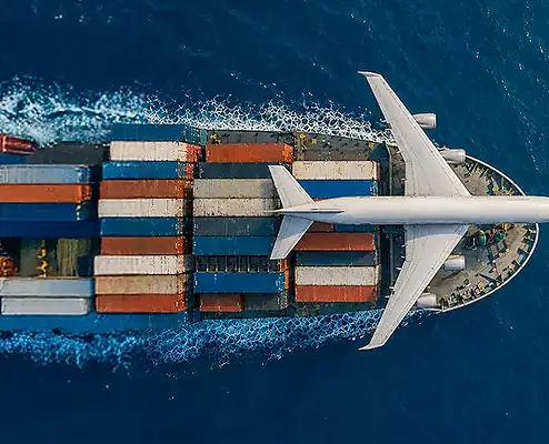A large container cargo ship sailing through open waters, loaded with colorful shipping containers, representing efficient freight transportation and logistics services.